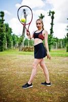 Beautiful sport woman tennis player with racket in sportswear costume. photo