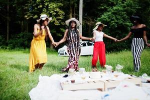 Group of african american girls celebrating birthday party having fun and dancing outdoor with decor. photo