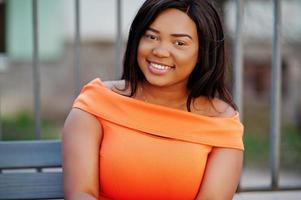 African american woman model xxl in orange dress. photo