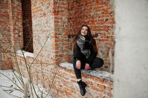 Brunette stylish casual girl in scarf against brick place. photo