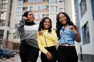 Three young college african american woman friends spend time together. photo