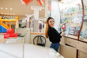 Portrait of young caucasian female woman seller. Small business of candy souvenirs shop. photo