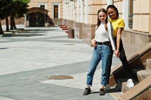 White caucasian girl and black African American together. World unity, racial love, understanding in tolerance and races diversity cooperation. photo