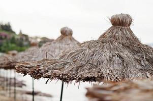 Bamboo and reed straw beach umbrellas. photo