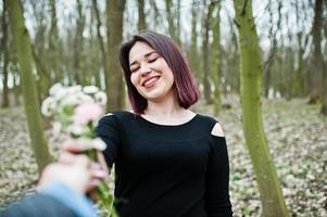 Portrait of brunette girl in black dress at spring wood. photo