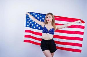 Cute girl in bra and shorts with american usa flag isolated on white background. photo