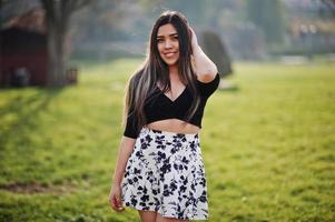 Pretty latino model girl from Ecuador wear on black tops and skirt posed at street. photo