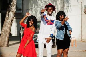 Group of three stylish trendy afro france friends posed at autumn day. Black african man model with two dark skinned womans. photo