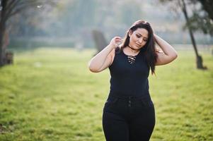 Pretty latino model girl from Ecuador wear on black posed at street. photo