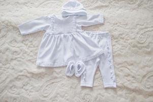 Snow white baby clothes for the rite of baptism. photo