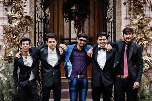 Group of 5 indian students in suits posed outdoor. photo