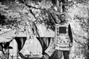 Handsome afro american man wearing traditional clothes in modern city. photo