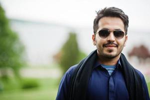 Stylish pakistani indian muslim arabic man in kurta dhoti suit and sunglasses. photo