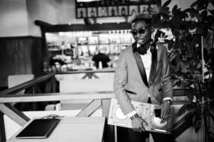 Fashion african american man model DJ at red suit with dj controller. photo