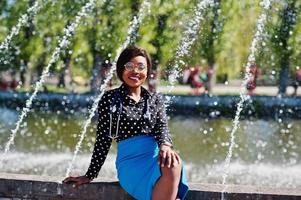 African american doctor female with stethoscope posed outdoor background fountains. photo