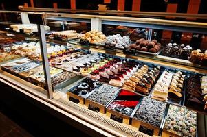 Various cakes on supermarket shelves for sale. photo