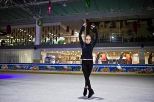 Figure skater woman at ice skating rink. photo