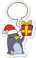 cartoon penguin and christmas present and speech bubble sticker vector