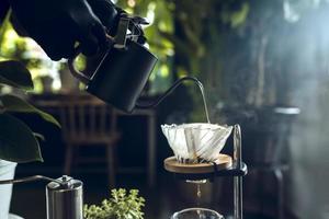 Vietnamese filtered or poured Vietnamese coffee dripping beer is a method that involves pouring water over the ground roasted coffee beans contained in a filter coffee shop in Asia. photo