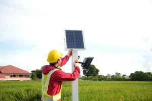 técnico de mantenimiento durante la instalación de paneles solares fotovoltaicos en tierras de cultivo foto