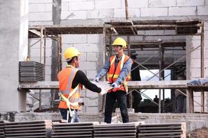 Lightweight brick mason is made of expanded clay. Elements in masonry construction The builder holds the bricks A man wearing a hard hat on a construction site photo