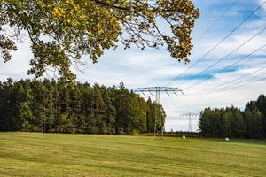 Electricity power lines crossing green countryside