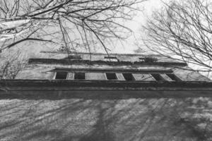 ruin in the forest in black and white photo