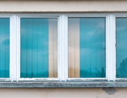 Windows with turquoise blue blinds photo