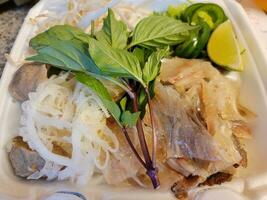 Vietnamese food tendon tripe basil and peppers in container photo