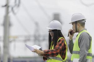 Two engineer working at power plant,Work together happily,Help each other analyze the problem,Consult about development guidelines photo