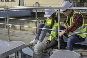 Environmental engineers work at wastewater treatment plants,Water supply engineering working at Water recycling plant for reuse,Technicians and engineers discuss work together. photo