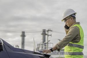 Asian man petrochemical engineer working at oil and gas refinery plant industry factory,The people worker man engineer work control at power plant energy industry manufacturing photo