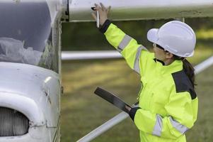 Technician fixing the engine of the airplane,Female aerospace engineering checking aircraft engines,Asian mechanic maintenance inspects plane engine photo