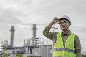 Asian man petrochemical engineer working at oil and gas refinery plant industry factory,The people worker man engineer work control at power plant energy industry manufacturing photo