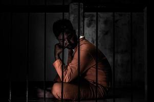 Asian man desperate at the iron prison,prisoner concept,thailand people,Hope to be free,Serious prisoners imprisoned in the prison photo