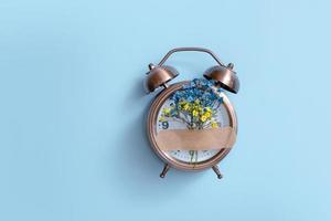 Blue and yellow flowers are glued on a sticky patch to the alarm clock. Ukrainian symbols photo