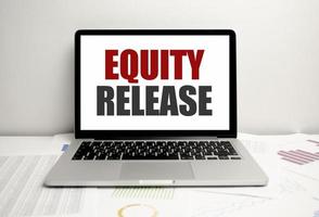 Equity Release words on laptop display and charts photo