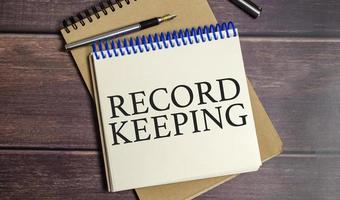 RECORD KEEPING symbol. Concept words Grow positive thoughts on notepad photo