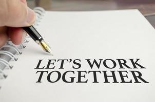 let's work together words and pen on white background photo