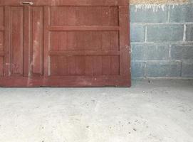 Old wooden door is laying near the brick wall. photo