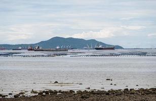 Many of the cargo ships are waiting near the harbor. photo