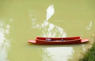 Leaky plastic row boats with the paddle. photo