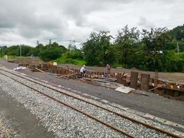 The group of workers is checking the bunting hole for the concrete pouring process. photo