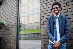 African man wear in tie and casual outfit posing outdoor. photo