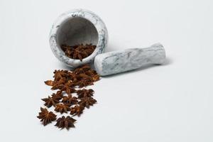 star anise illicium verum with a marble pestle and mortar