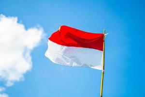 Indonesian flag with sky background photo