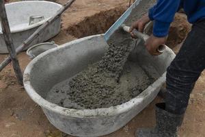 Cement mixed with stone Pour it onto a mortar mixing truck. That is being used by workers. photo