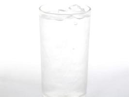 Ice in a clear glass on a white background is ice for chilling and drinking water. Eat. Then give energy-life and freshness-Water is important in this world whether people or animals. photo