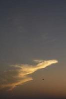 Different shapes of animal-like clouds and multicolored clouds were floating in the air as the atmosphere on the evening before sunset was different for each day. photo