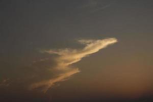 Different shapes of animal-like clouds and multicolored clouds were floating in the air as the atmosphere on the evening before sunset was different for each day. photo